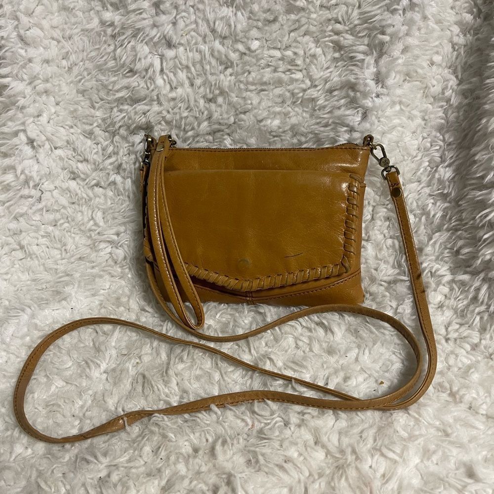 HOBO Cadence Leather tan Crossbody bag made with a convertible strap.